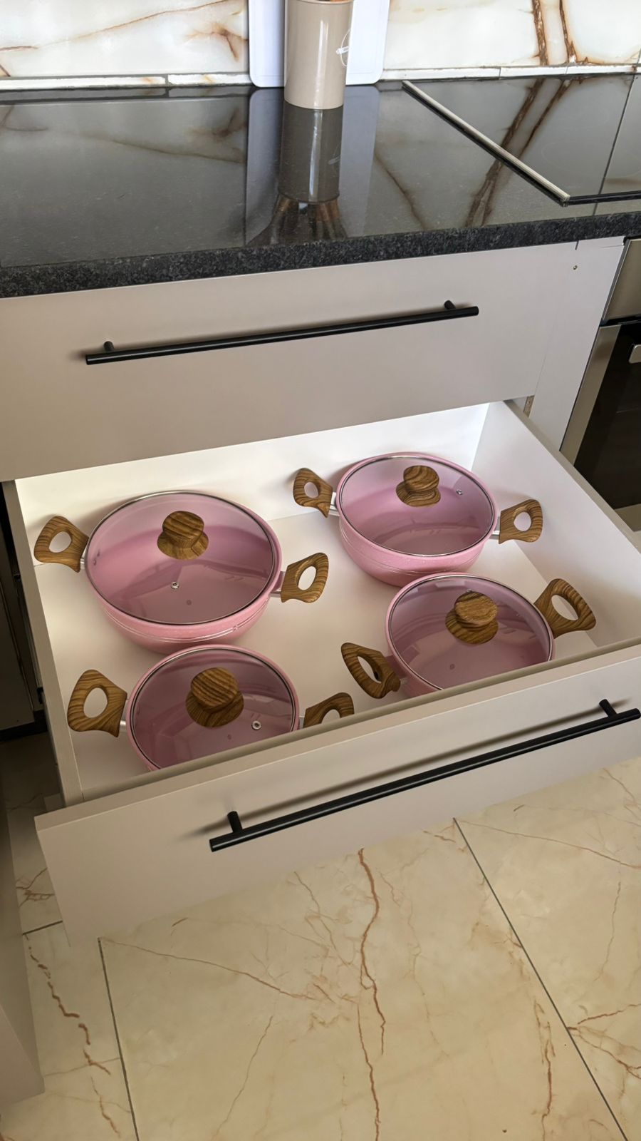 Kitchen drawer with pink cookware set