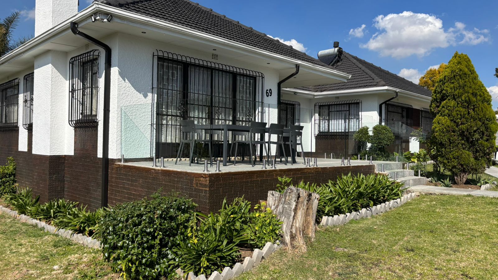 Front patio with outdoor chairs and garden planting