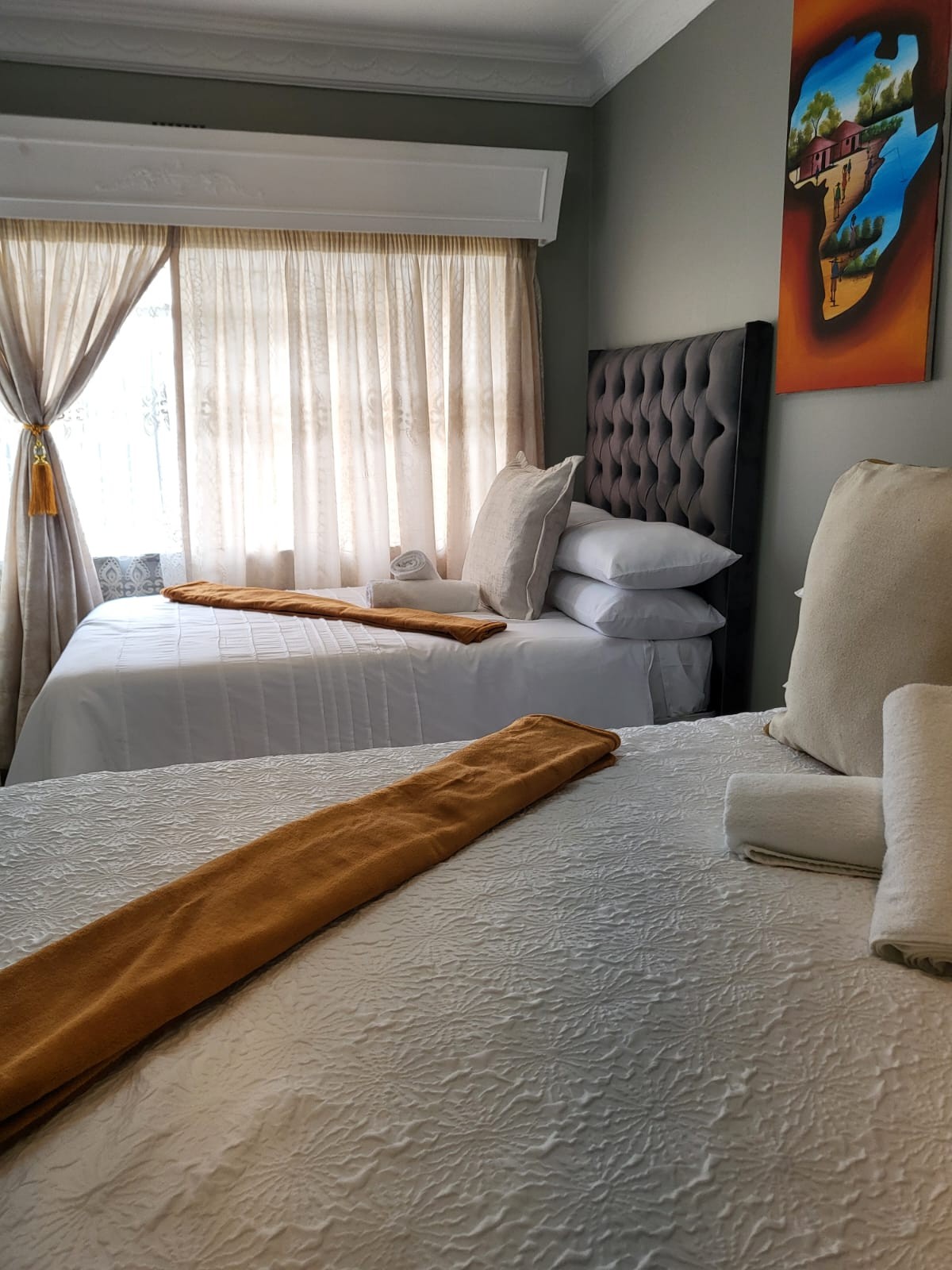 Second view of Room 4 with a double bed and single bed